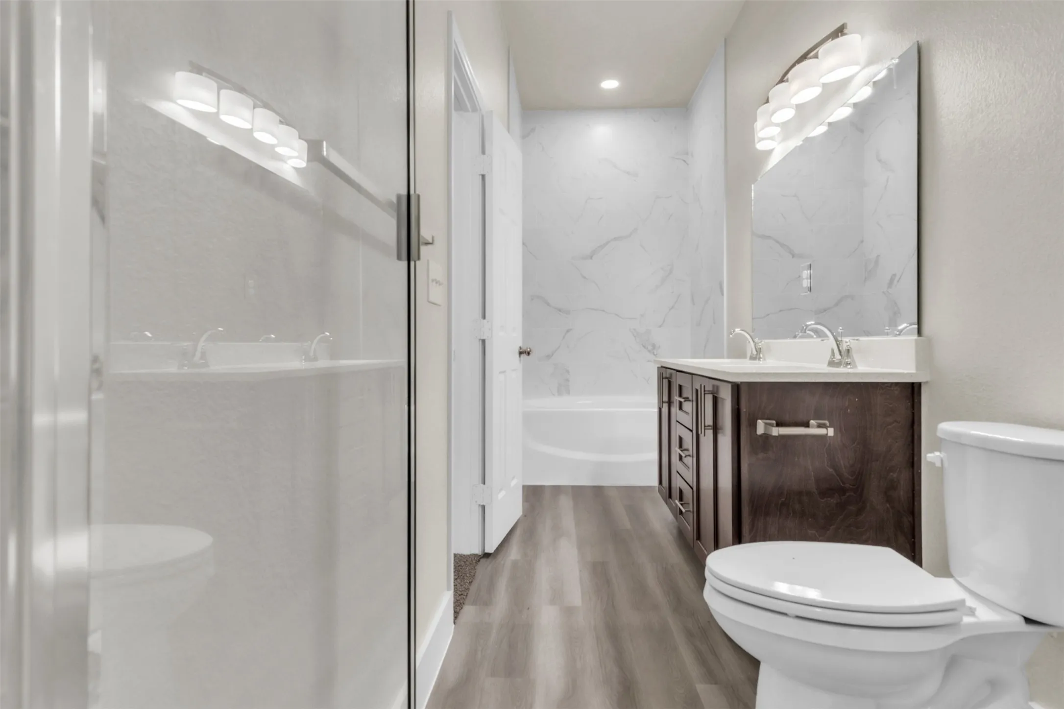 Primary bath with separate tub and spa shower with seat