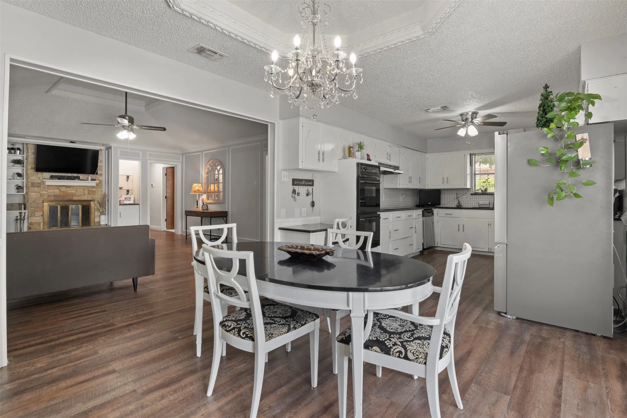 Kitchen and dining area featuring wood-finish flooring