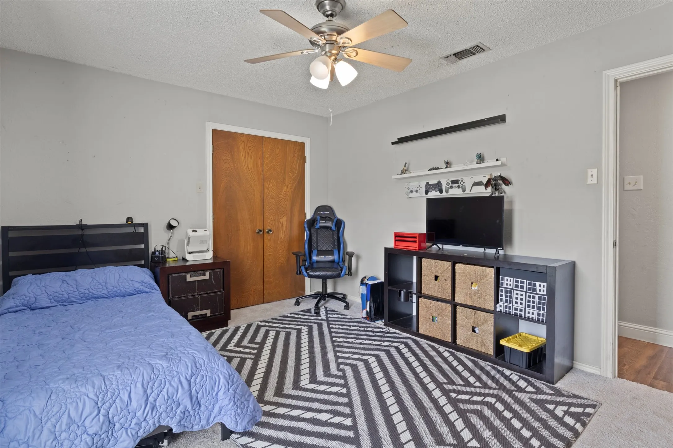 Interior room featuring a ceiling fan with integrated lighting, neutral wall paint, and carpet flooring