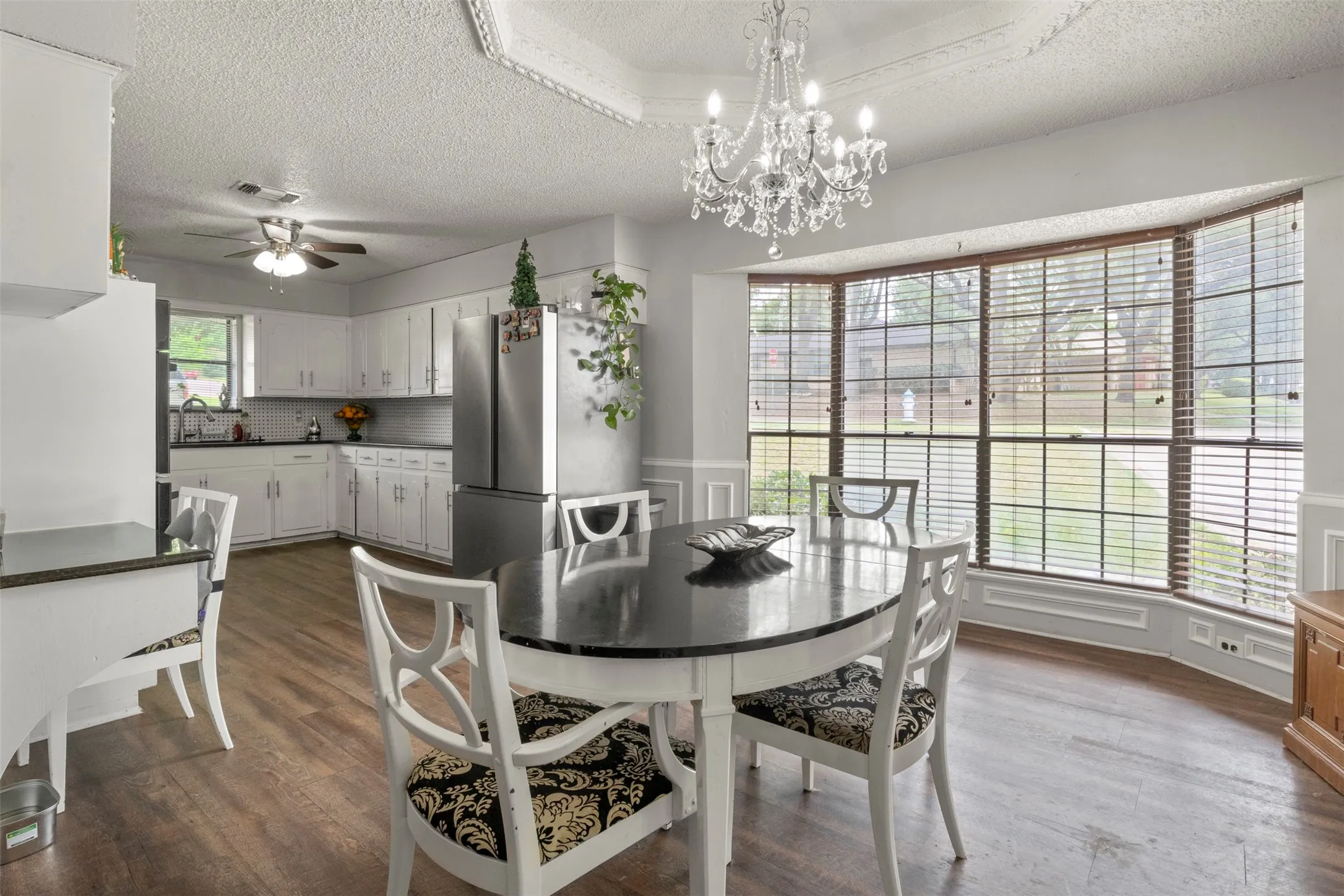 Open-concept kitchen and dining area with wood-finish flooring