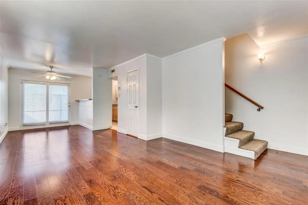 Open-concept living area featuring rich wood-finish flooring