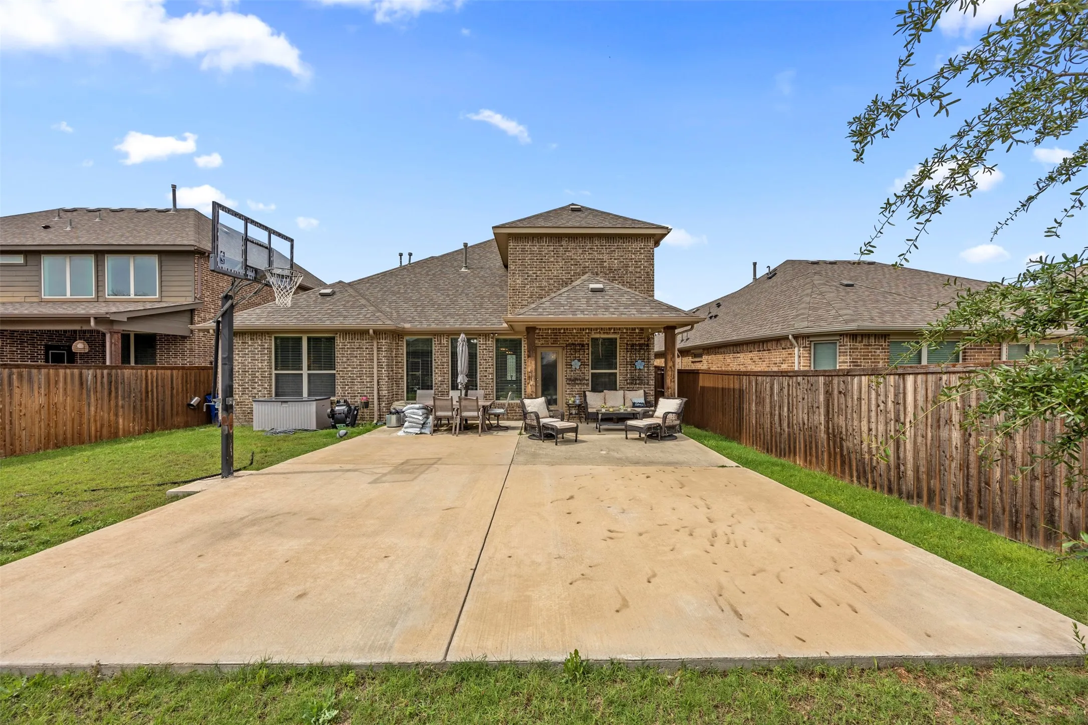 Expansive concrete patio with integrated basketball hoop