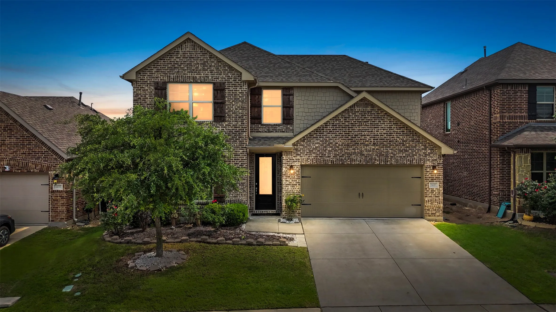 Two-story brick and siding exterior with a pitched roof and attached garage