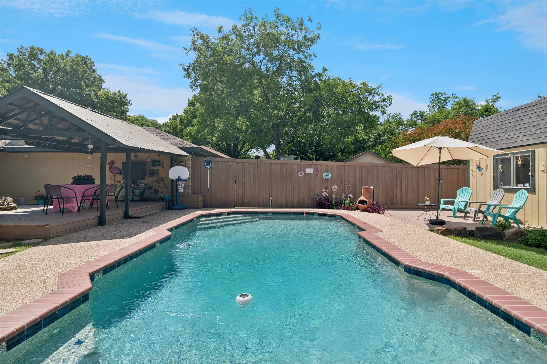 Beautiful pool with decking and covered arbor area
