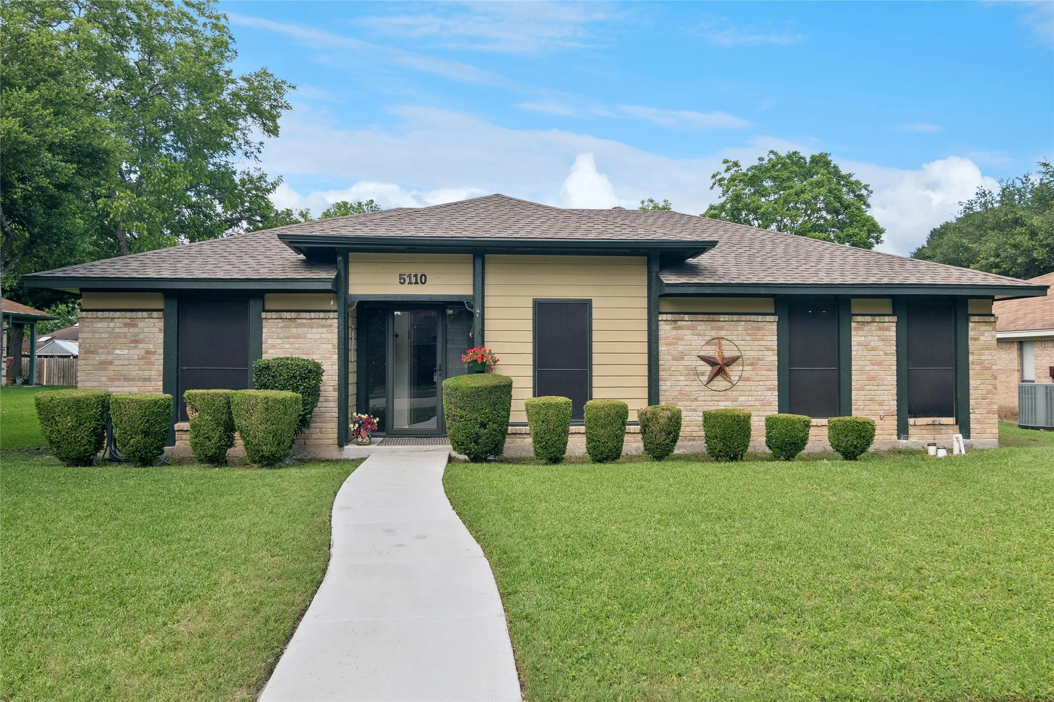 Brick exterior with contrasting trim & nicely landscaped yard
