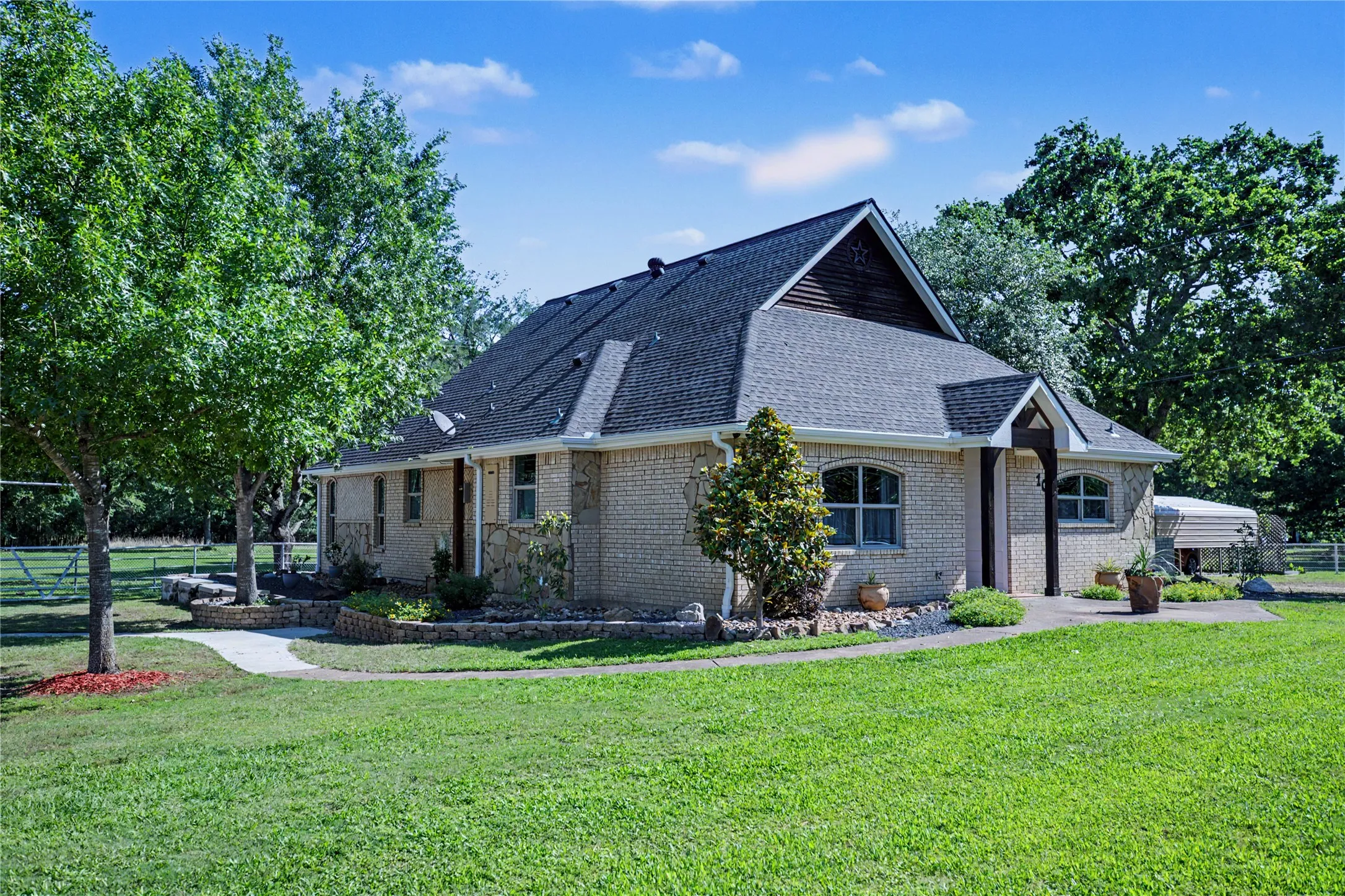 Brick exterior with gabled roofline and dark shingle roofing