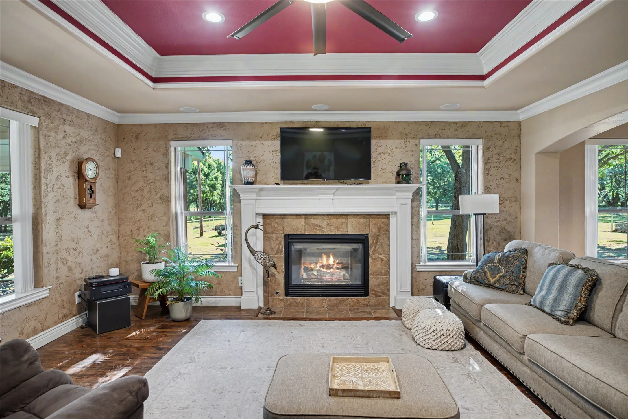 Living space featuring a central fireplace with stone tile surround and a substantial white mantelpiece