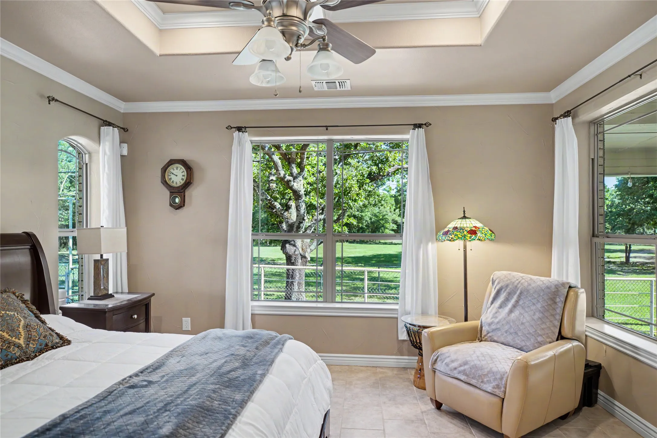 Room with a tray ceiling and a ceiling fan light fixture