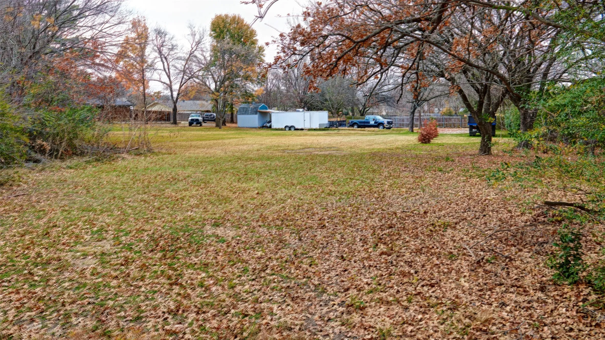 Expansive lot featuring mature trees and a substantial open area