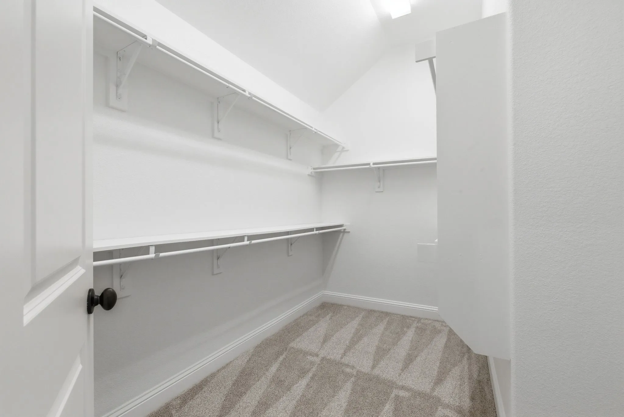 Huge primary closet with lots of shelving