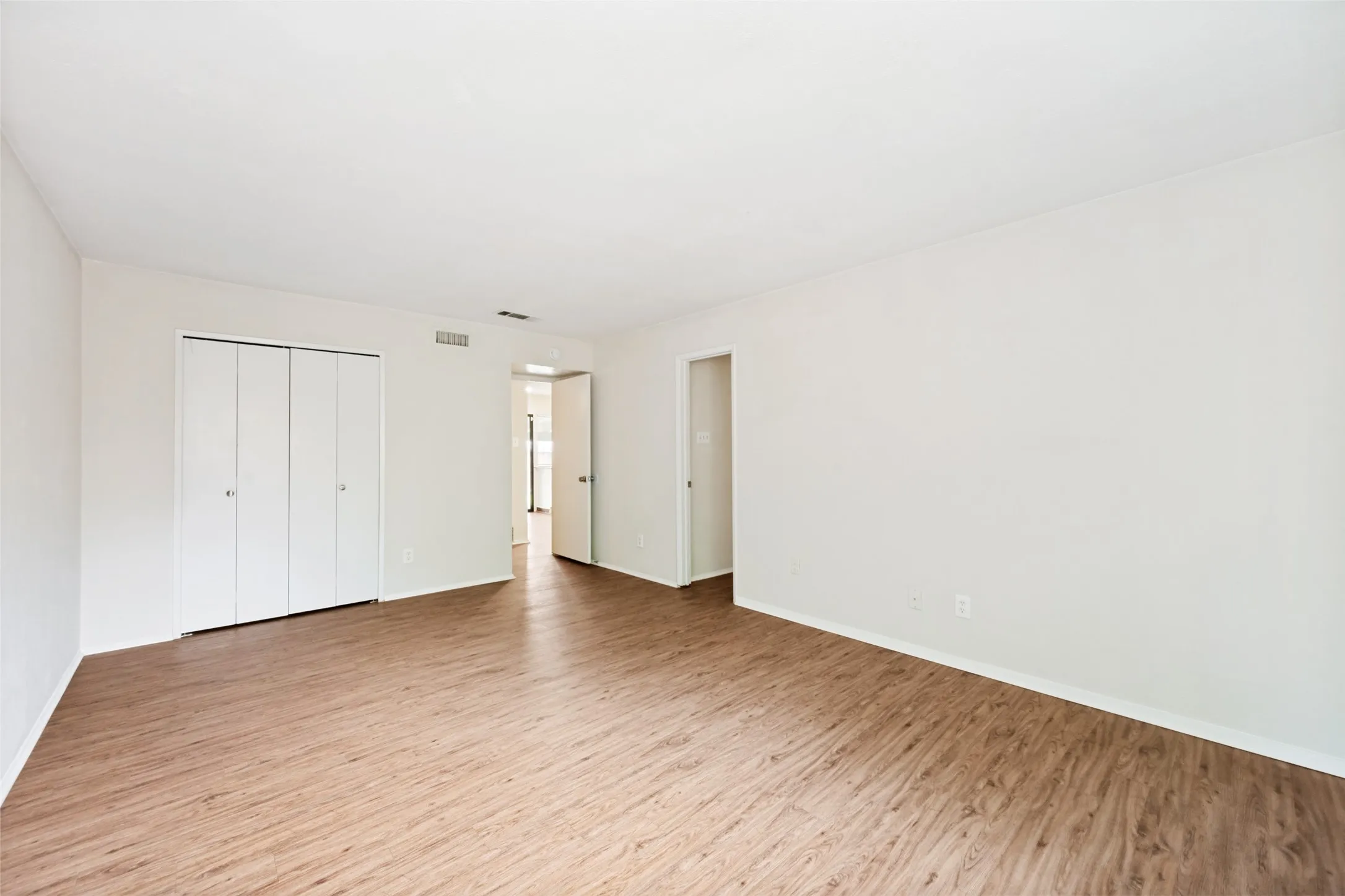 This view shows the closet and the entry door to the room and the bathroom.
