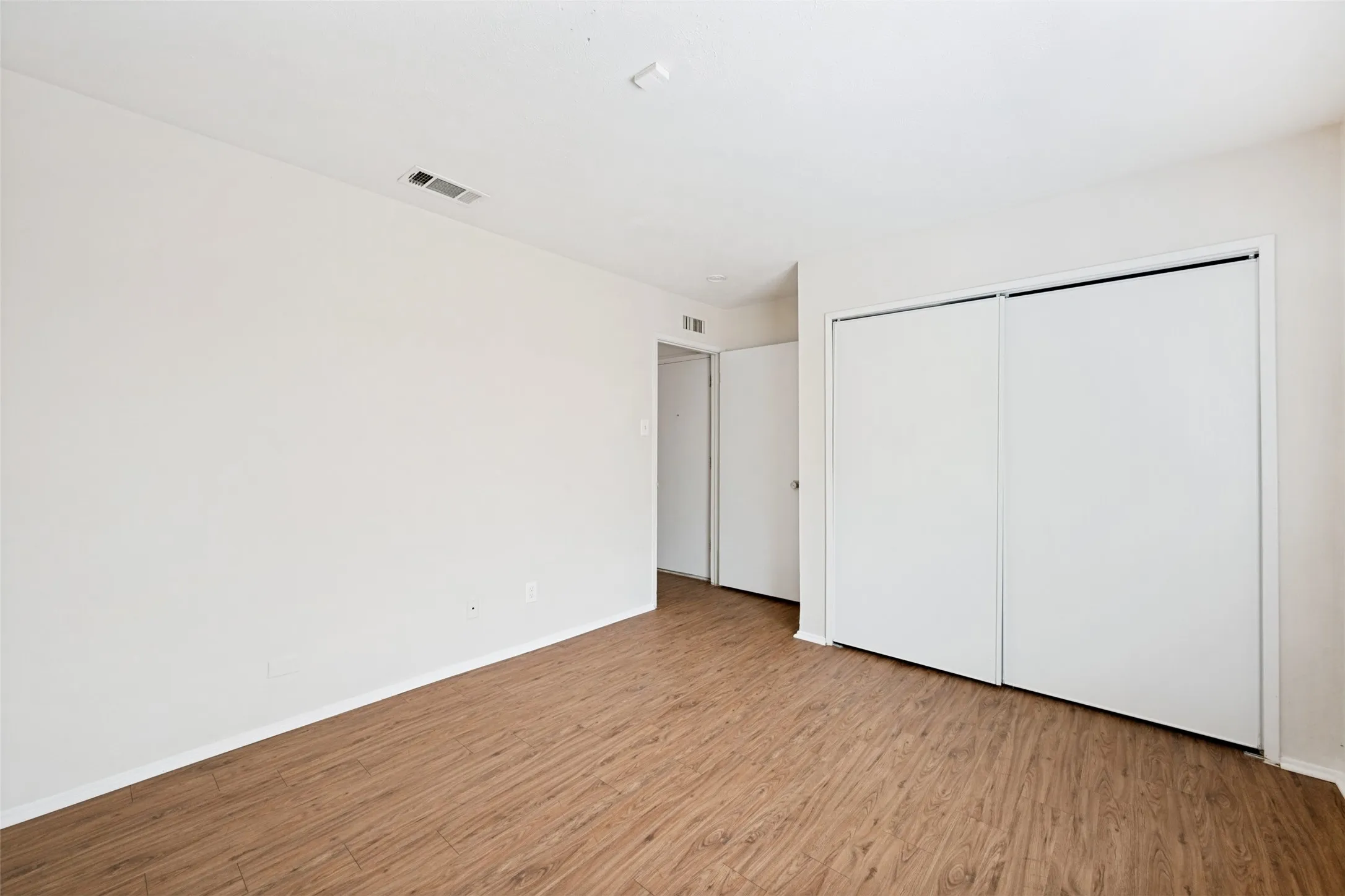 View of closet and doorway to secondary bedroom, the smaller of the 2.