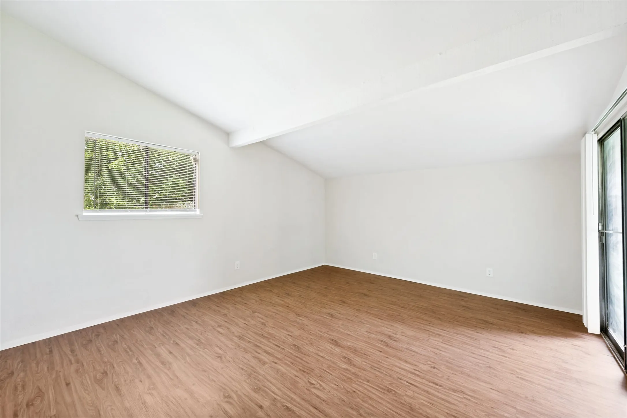 The sloped ceiling adds to the character of the primary bedroom.