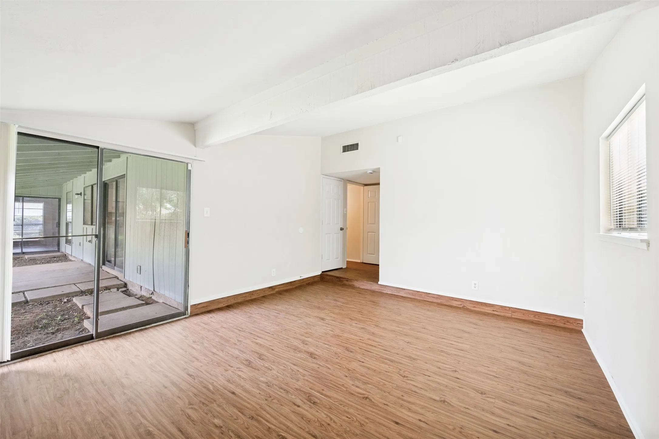 Primary bedroom with exterior entrance to the patio.