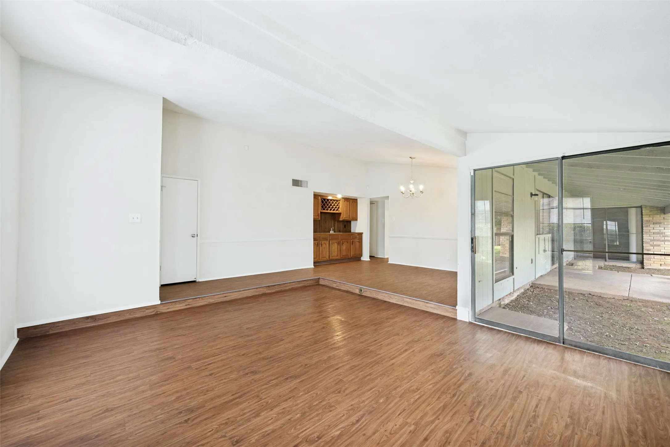 The view show the dining room in relation to the fireplace and the living area.