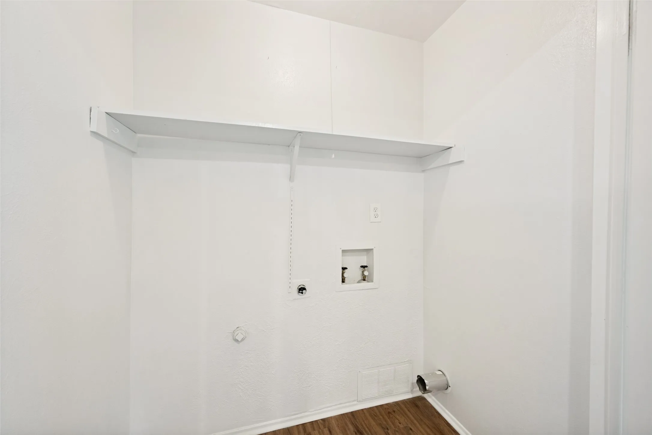 The laundry area is in a closet in the kitchen.