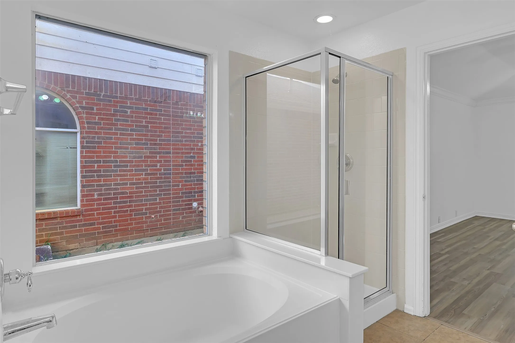 Bathroom with a garden tub, a stall shower, tile patterned floors, and recessed lighting