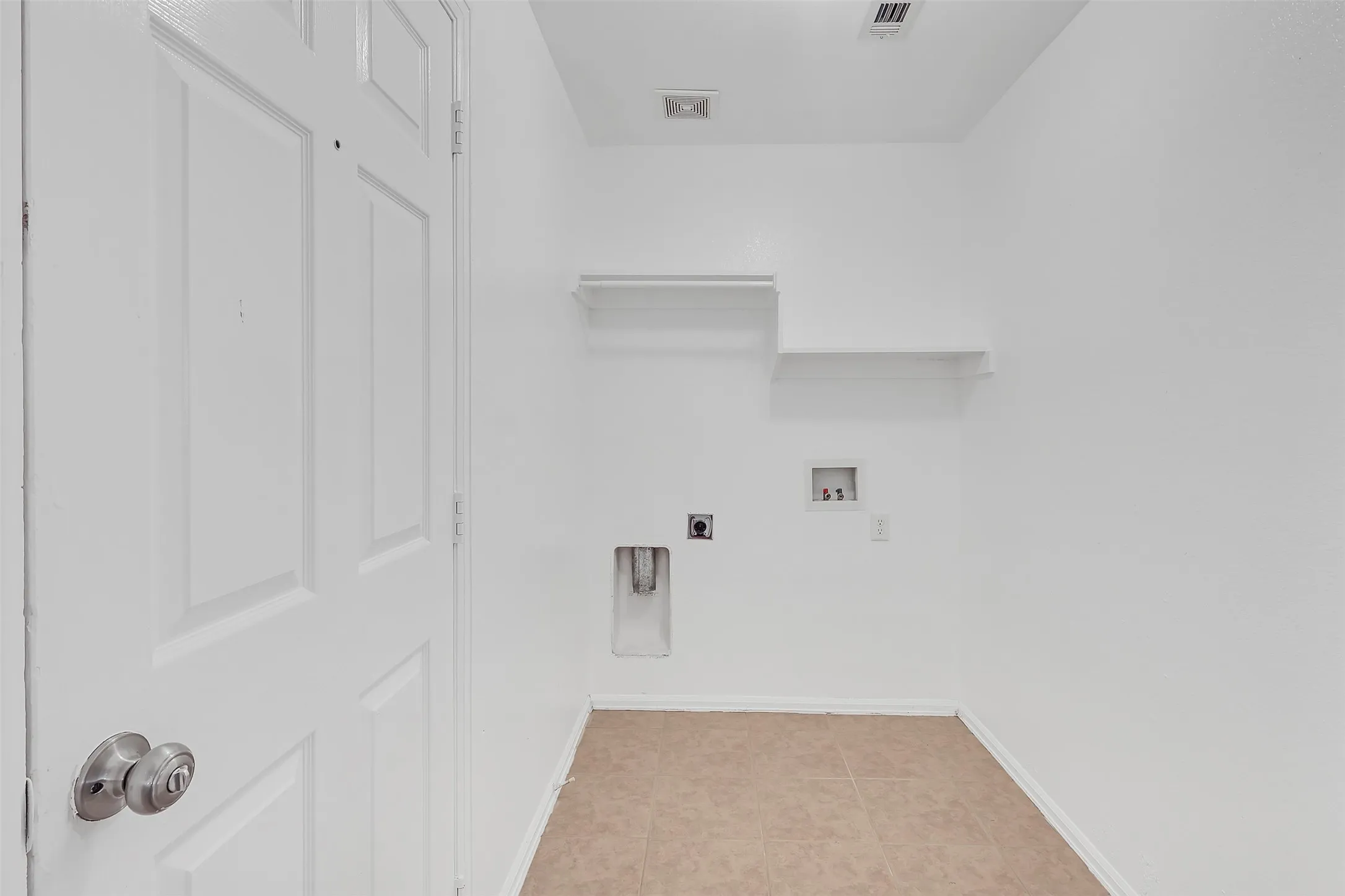 Laundry room featuring light tile patterned flooring, hookup for an electric dryer, and hookup for a washing machine