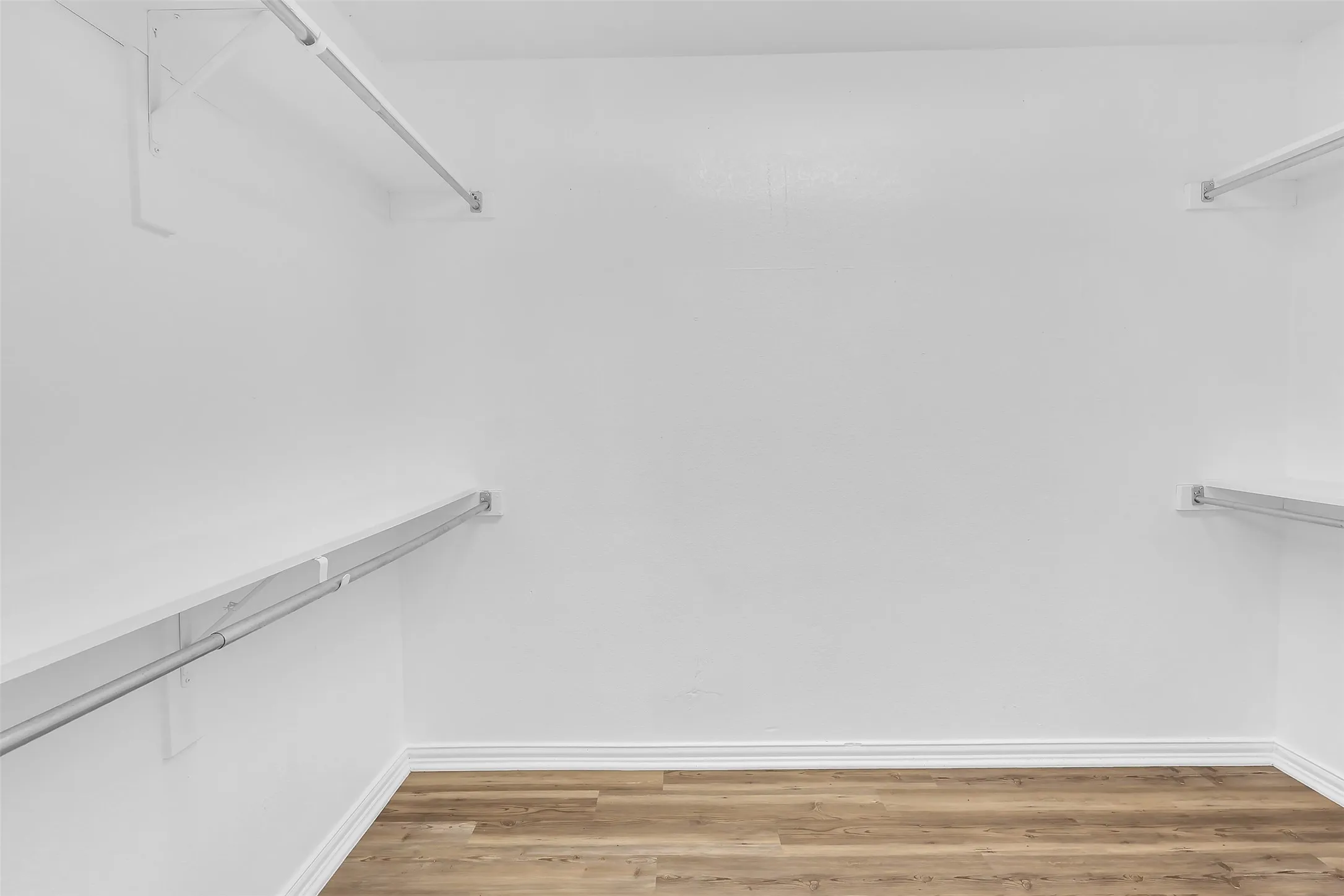 Spacious closet with light wood-style floors and attic access