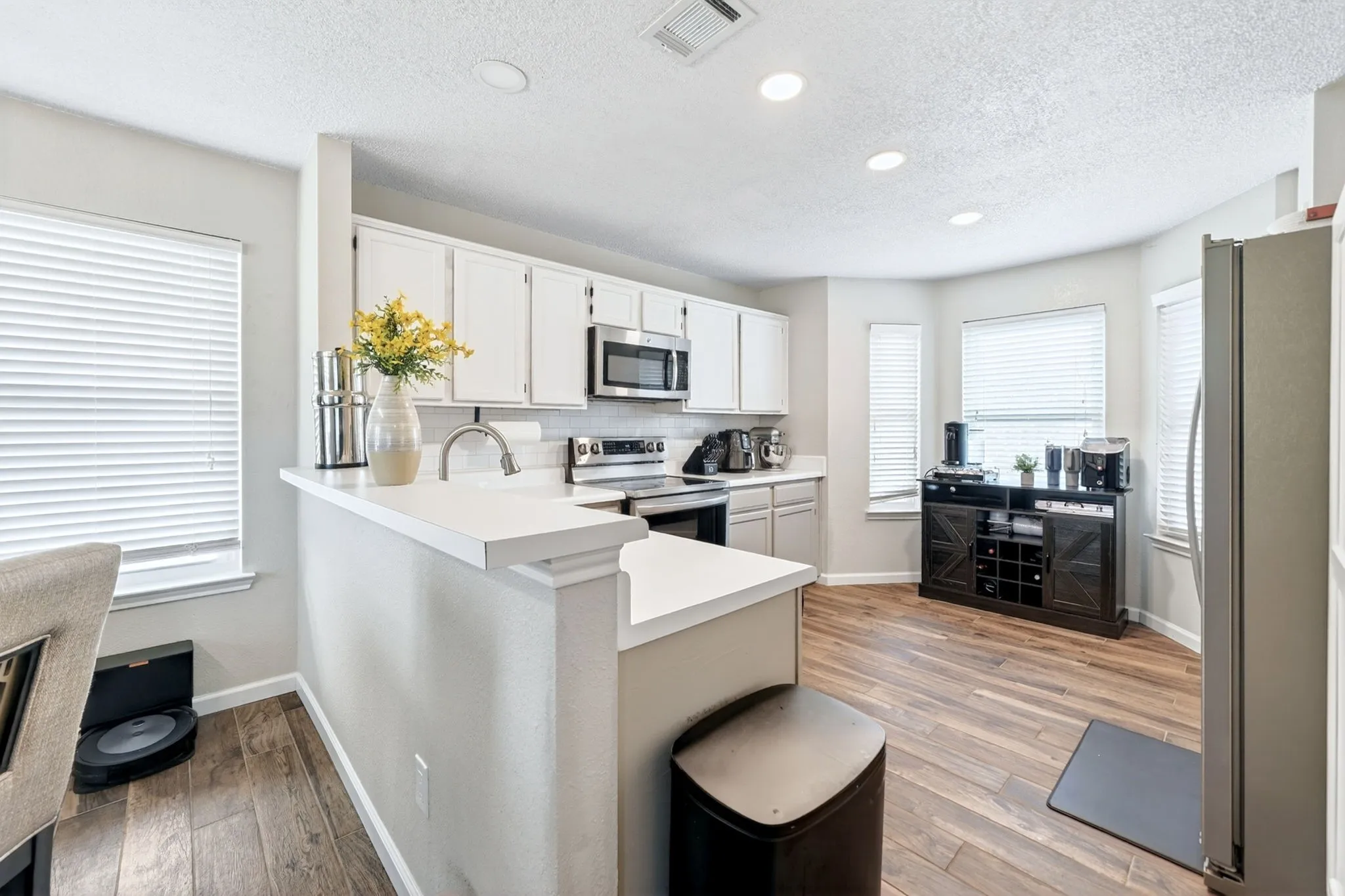 Kitchen featuring white cabinetry and stainless steel appliances