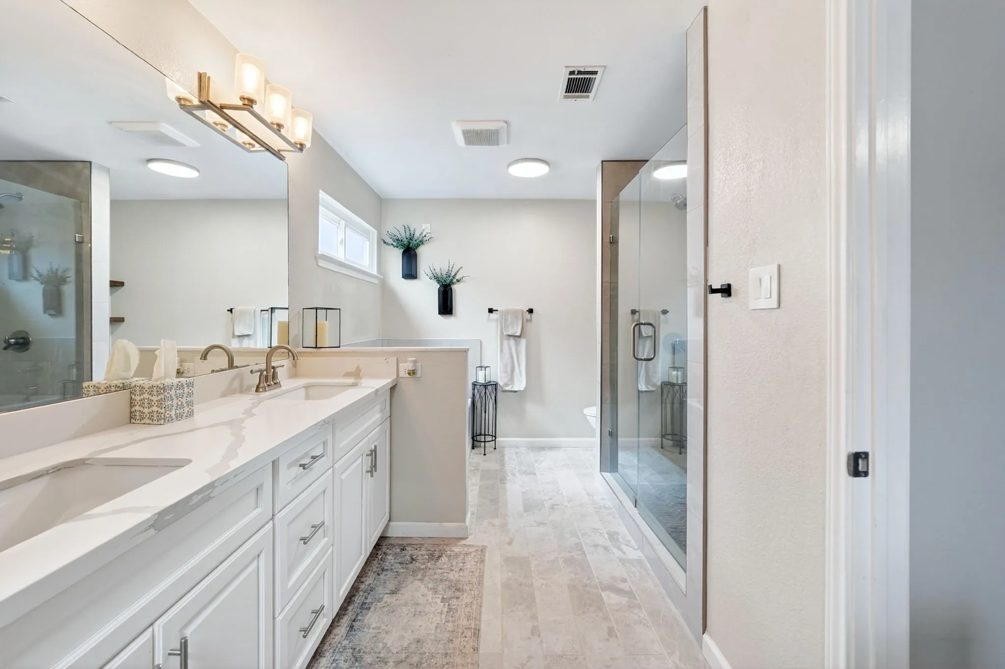Double vanity with undermount sinks and white shaker cabinetry