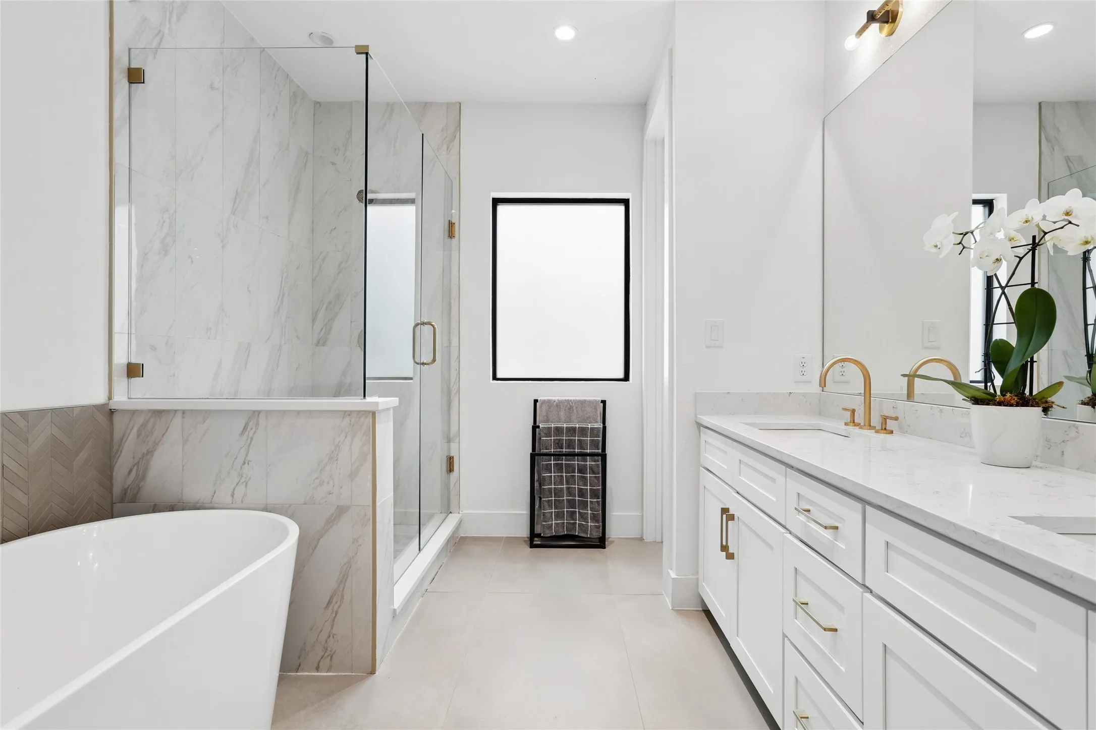 Spa-inspired ensuite bath offers a free-standing soaking tub, a separate shower, and dual sinks