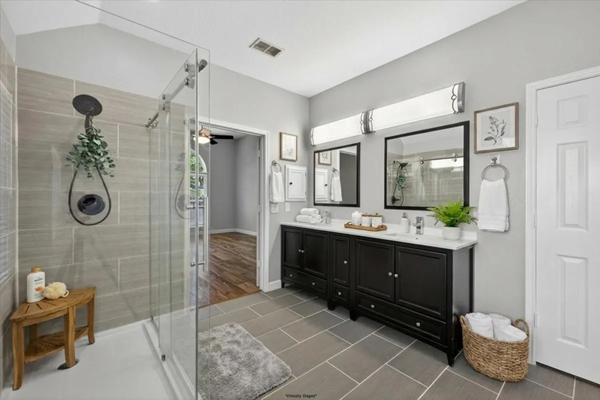 Dual vanity with dark wood cabinetry and white countertops