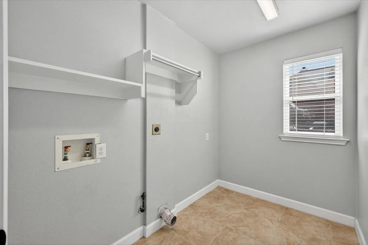 Utility room featuring ceramic tile flooring and light gray walls