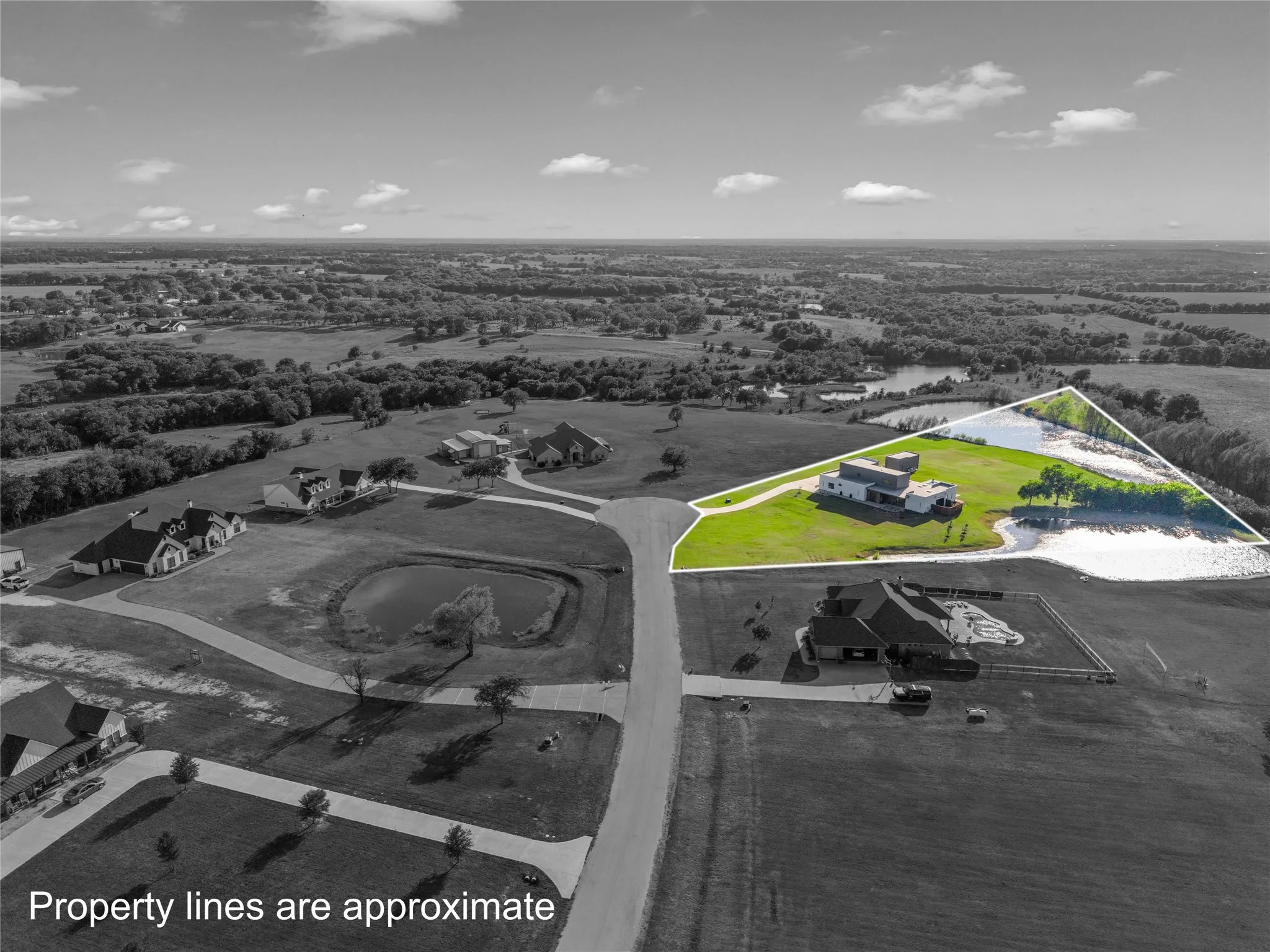 Expansive property featuring a modern residence, extensive green space, and a private pond