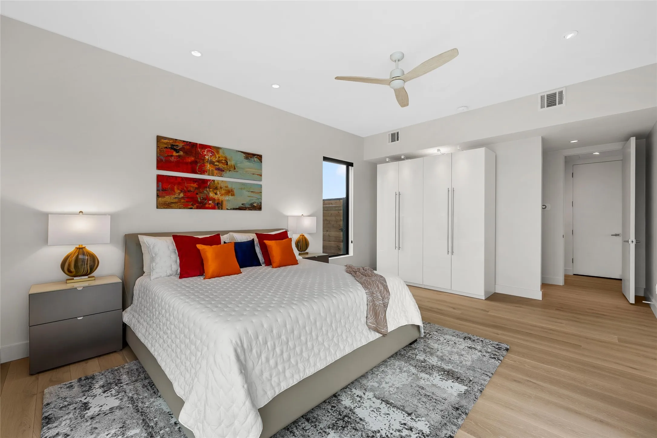 Light wood-finish flooring complemented by a contemporary ceiling fan