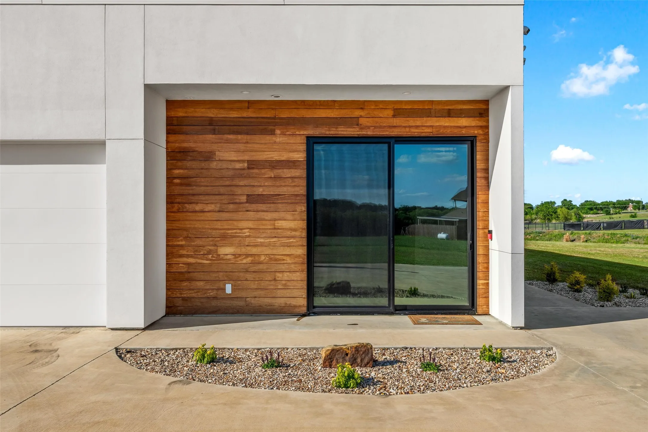 Modern exterior facade featuring sleek white paneling and rich wood-finish siding