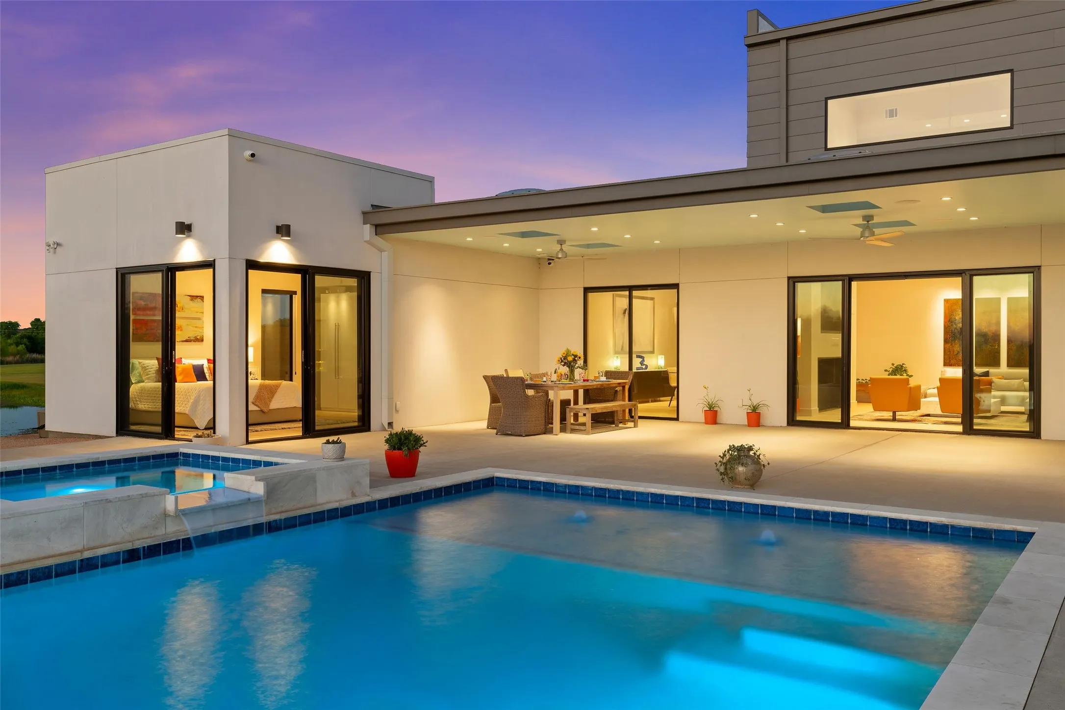 Outdoor pool and spa with blue tile accents