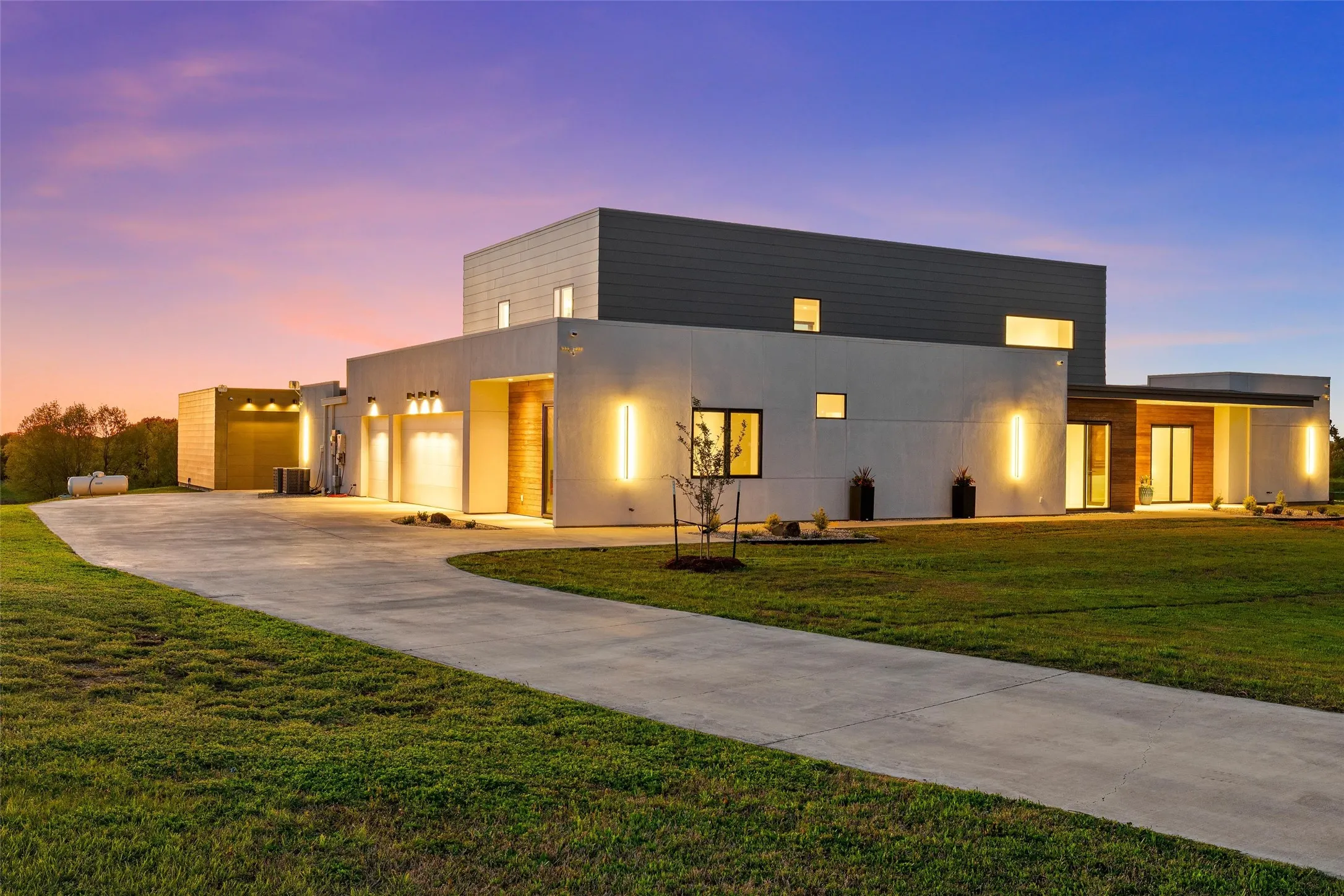 Modern architectural exterior featuring a multi-level design with white and gray facades