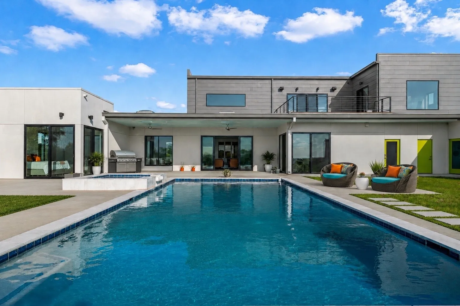 This picture has been virtually staged. Outdoor pool and spa with blue tile accents