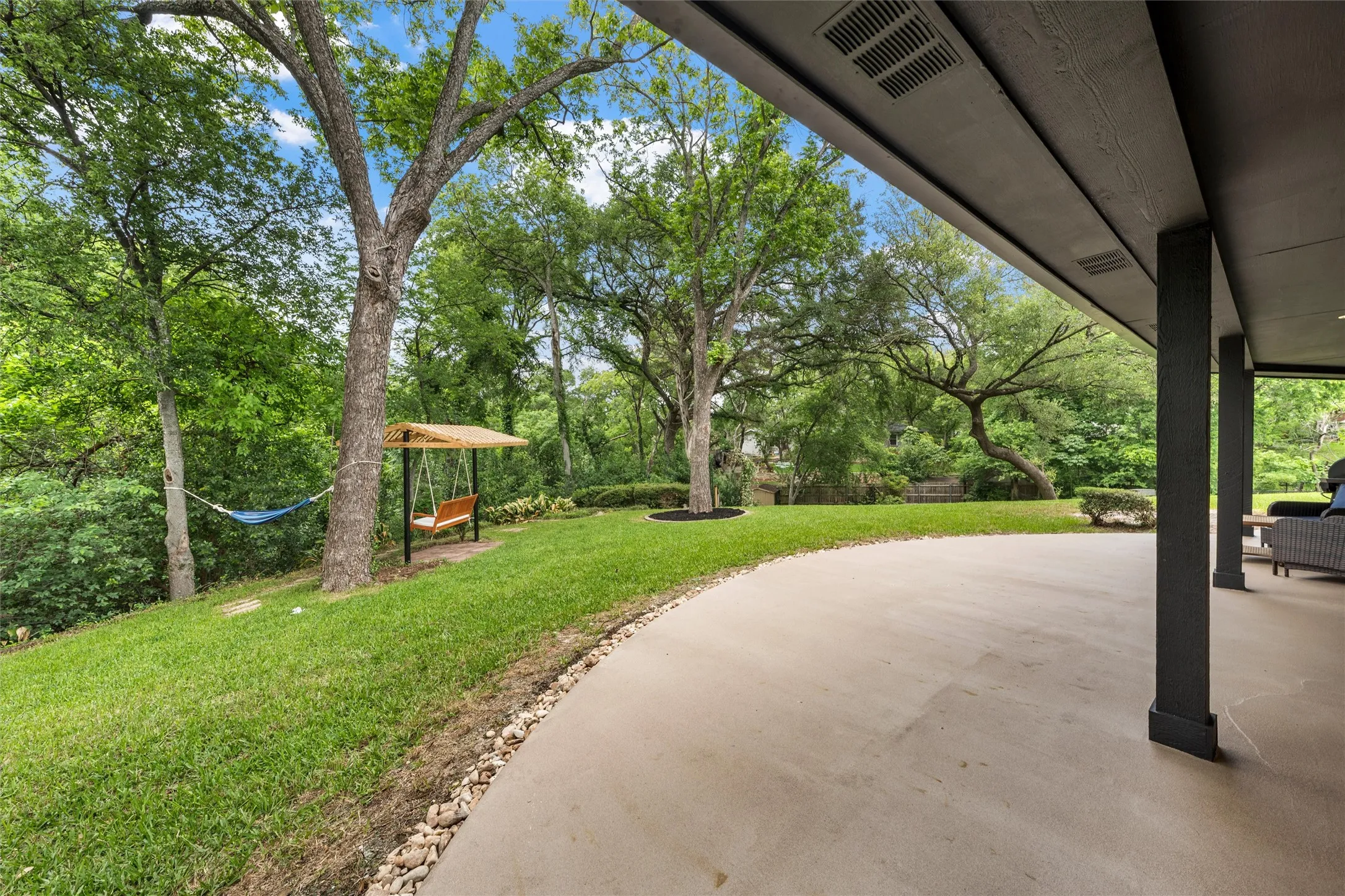 Expansive concrete patio offering a broad outdoor living area