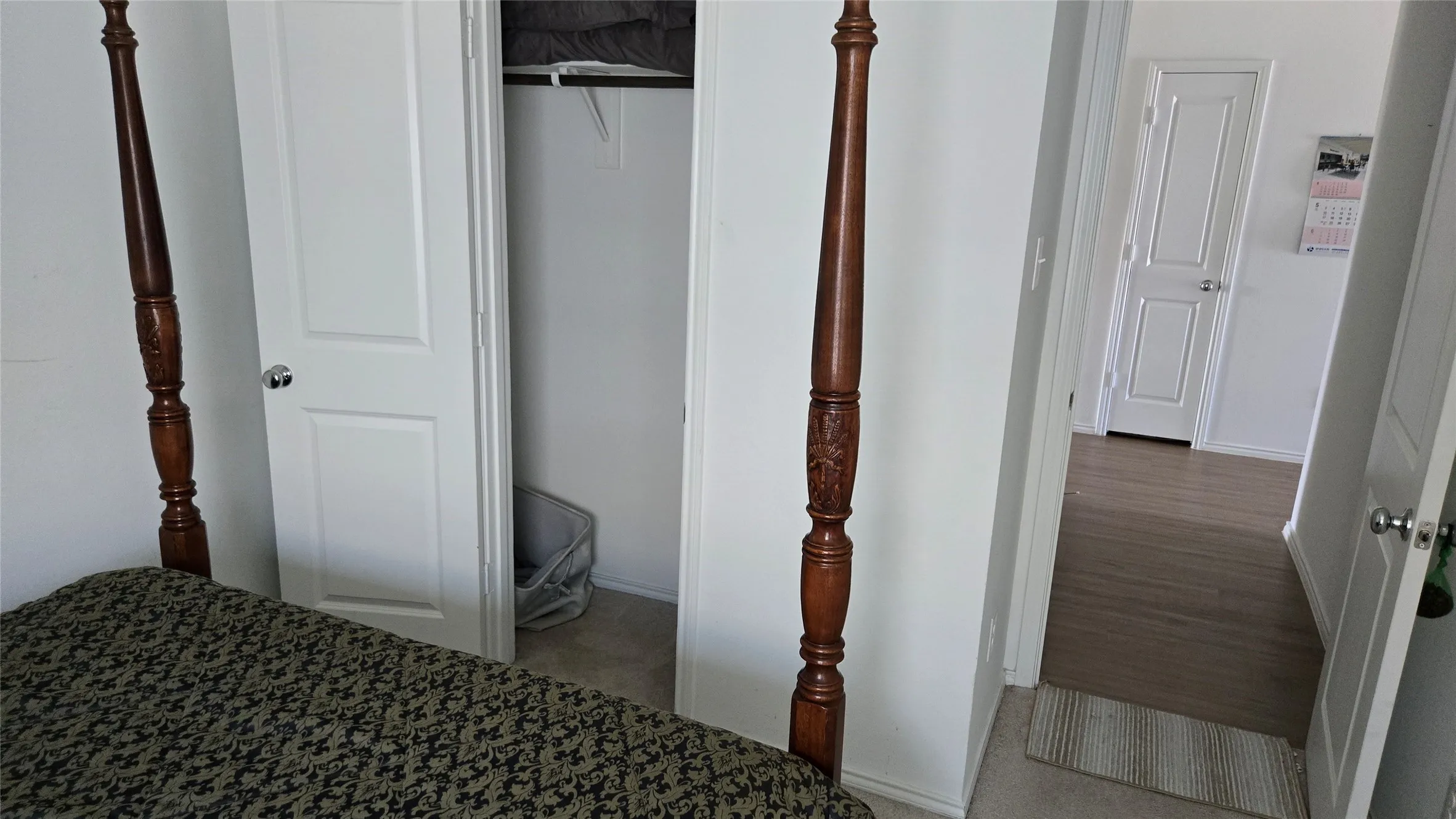 Room interior featuring white walls and a carpeted floor
