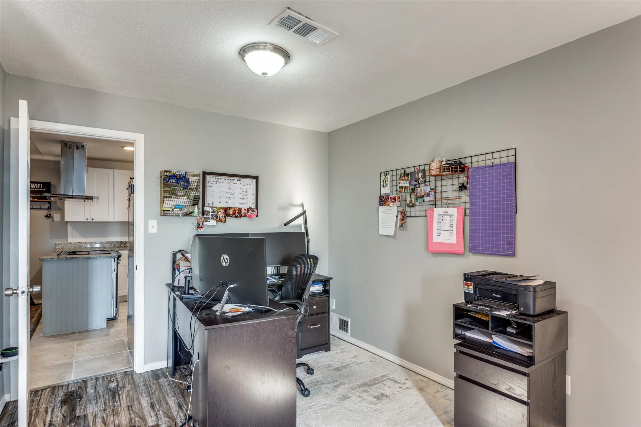 Room with wood-finish flooring and light gray walls