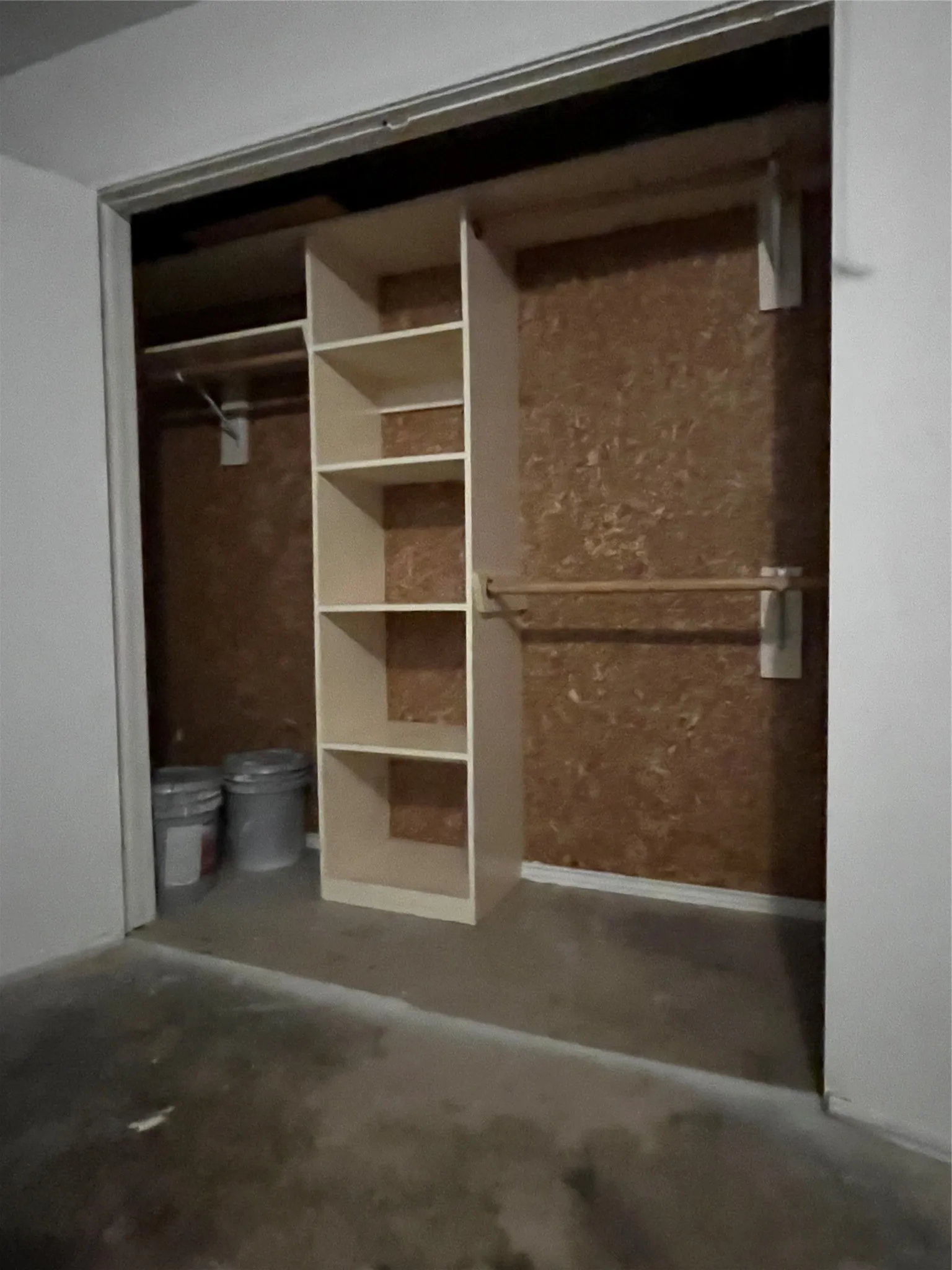 Cedar closet in garage with hanging racks and built-in shelves