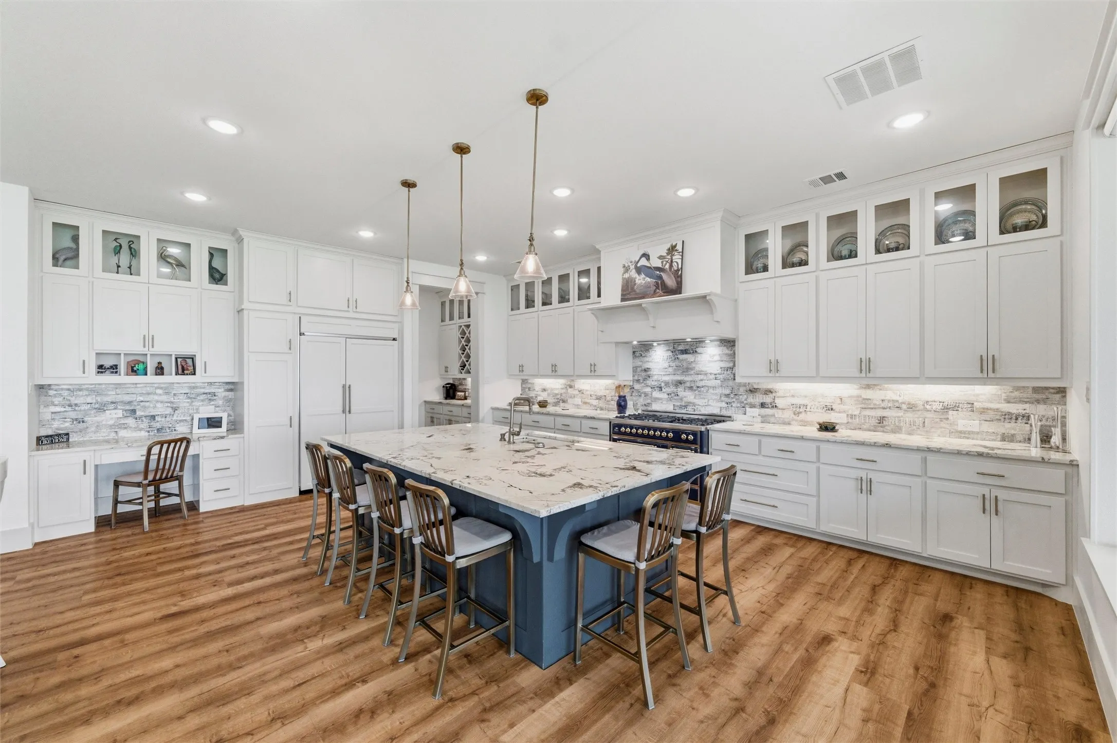 Dining area is positioned between the kitchen and living spaces with large windows and sliding glass doors overlooking the waterfront setting. Open layout creates seamless flow throughout the main living areas with room for both casual and formal dining arrangements.