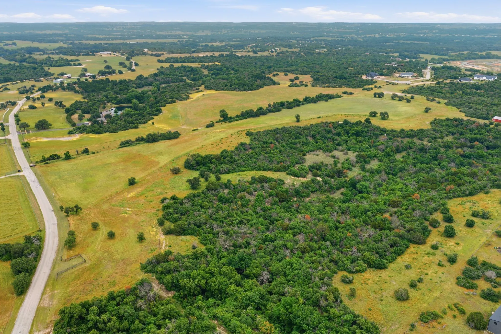 An incredible bird’s-eye view displays the property’s scenic terrain, dotted with mature trees and framed by endless Texas countryside in every direction.