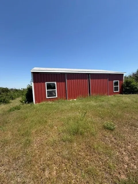 A picturesque red barn serves as a stunning focal point on the property, perfectly complementing the peaceful rural surroundings.