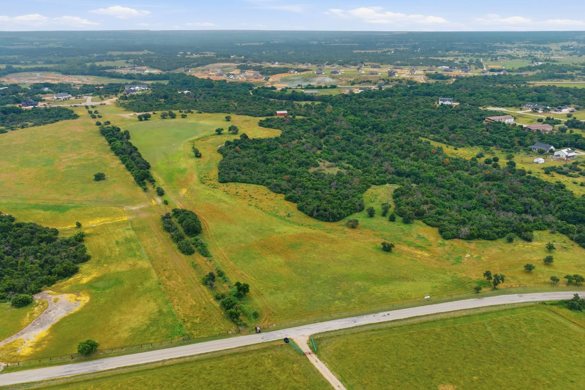 Towering above the landscape, this aerial perspective captures the perfect balance of privacy, natural beauty, and development potential across all 54 acres.