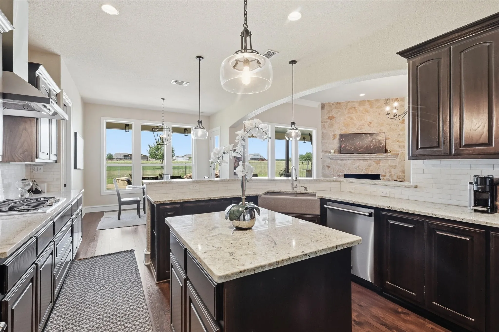 Large Kitchen with Updated Lighting, Viking Appliances, and Granite Countertops Overlooking the Dining and Livingroom.
