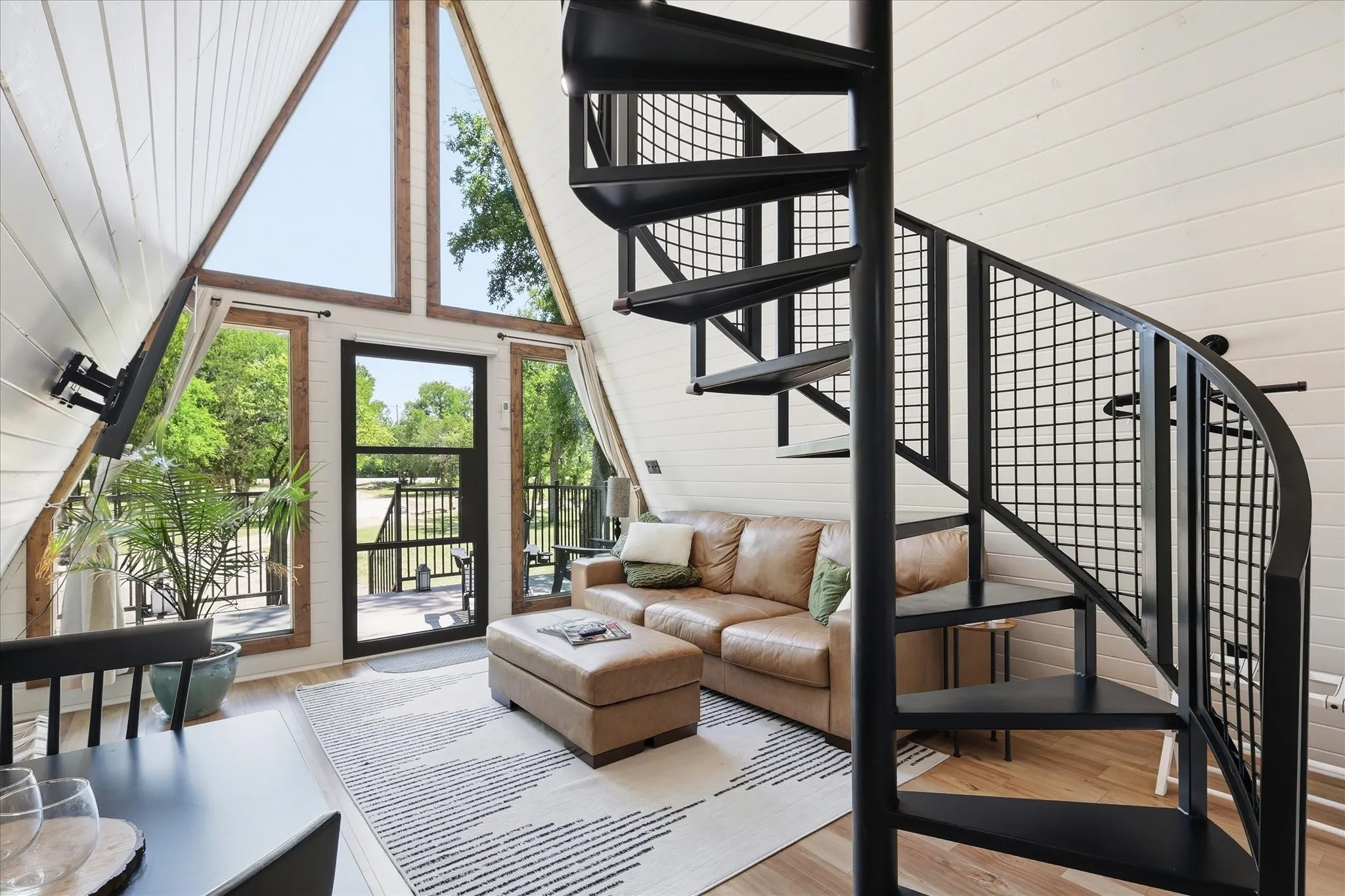 Living Room with Spiral Staircase to Loft.