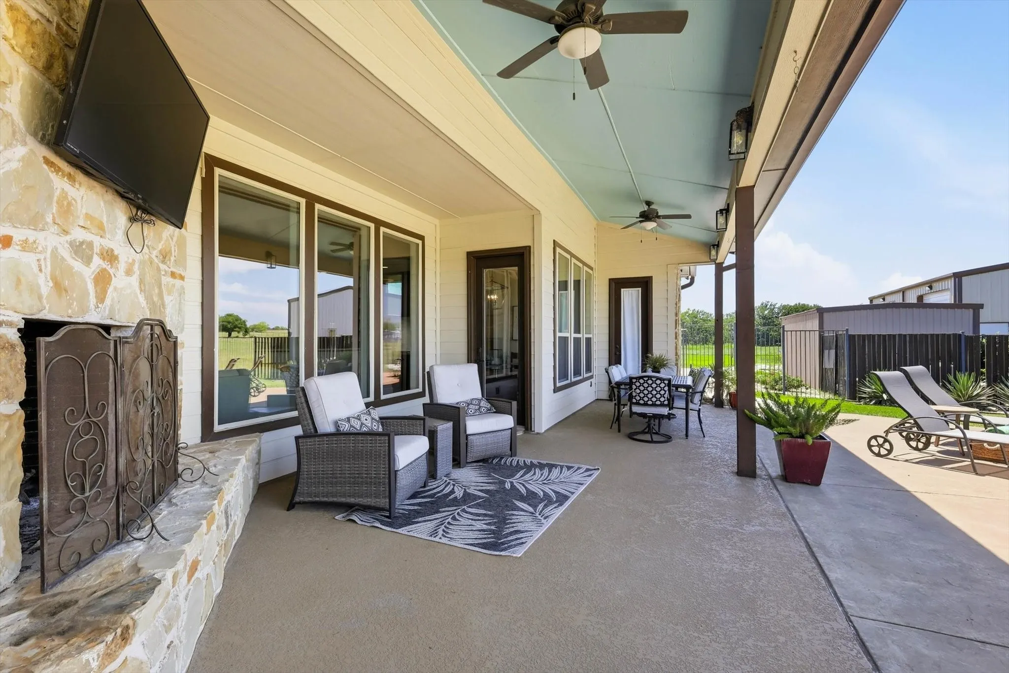 Large Covered Patio with Outdoor Gas Fireplace and Large Amount of Seating.