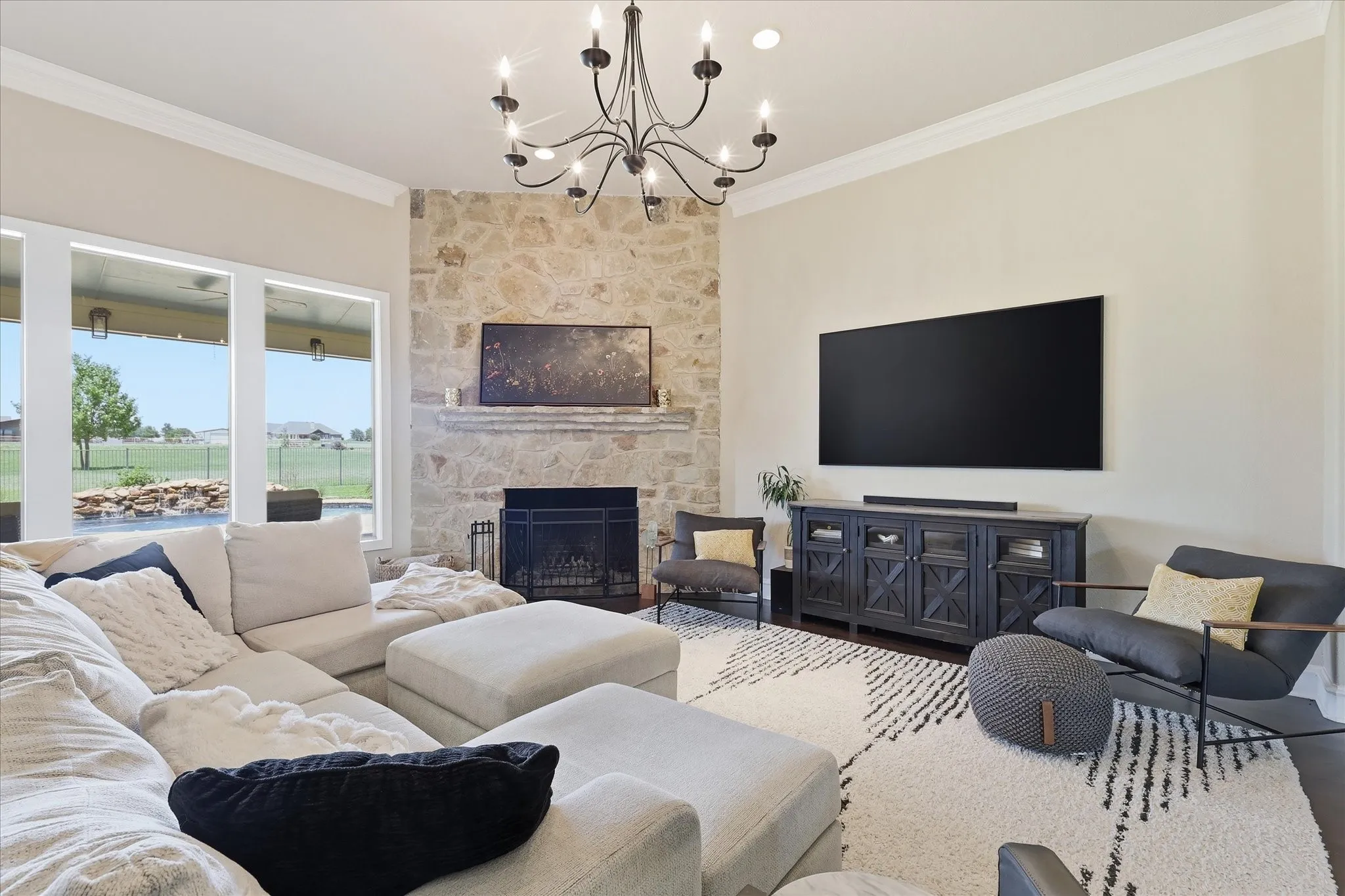 Large Living Room with Oversized Fireplace and Chandelier.