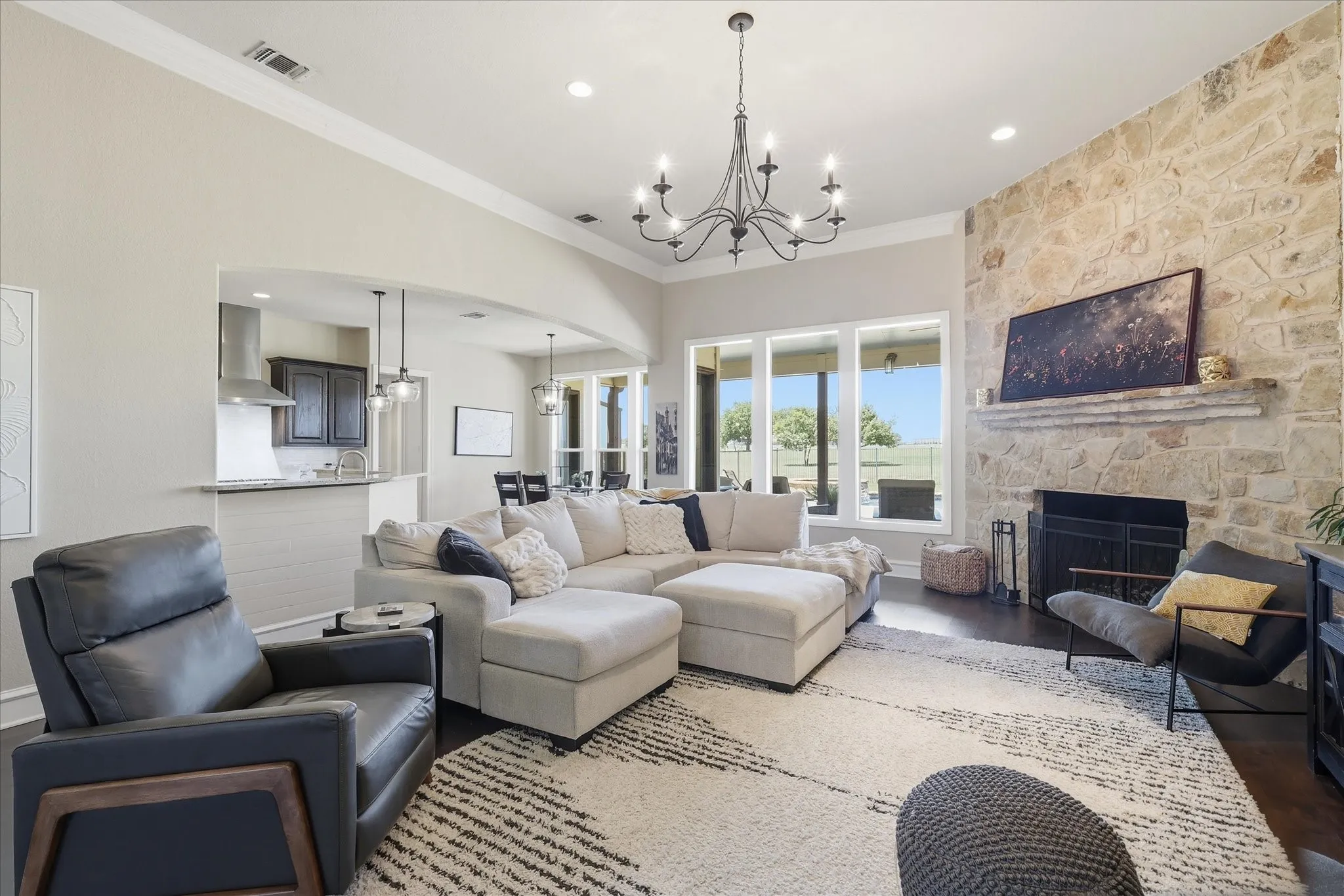 Large Living Room with Oversized Fireplace and Chandelier.