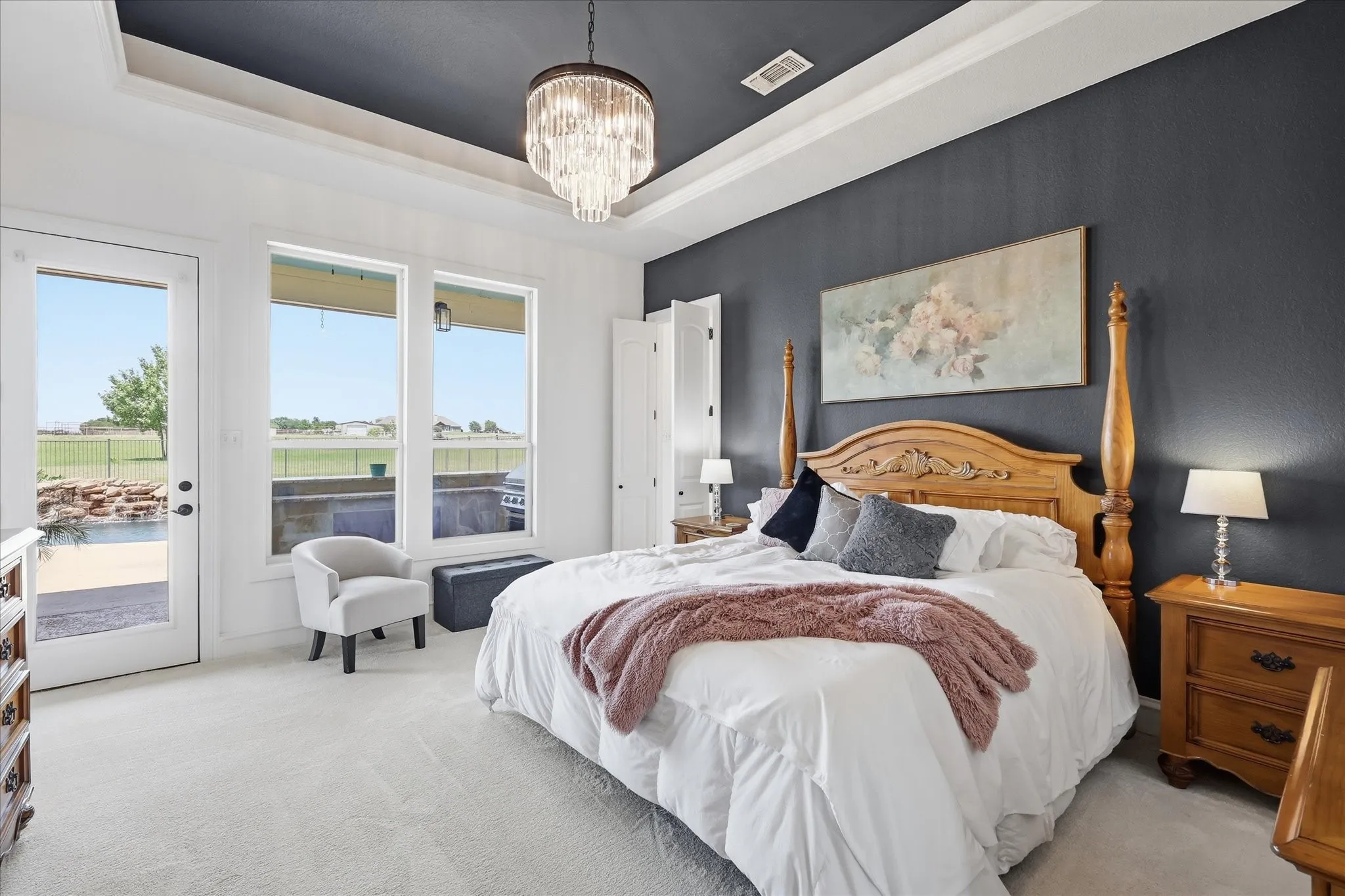 Primary Suite with an Abundance of Natural Light and Overlooking the Pool.