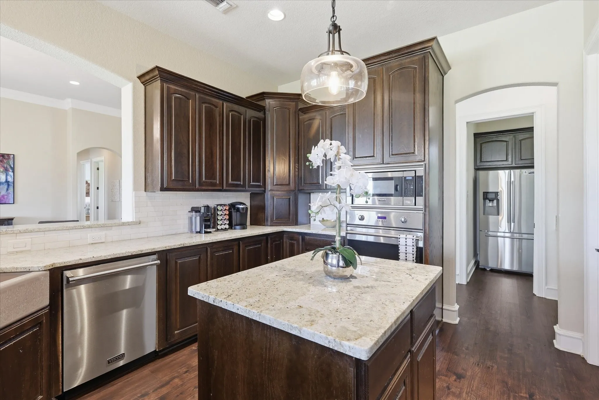 Large Kitchen with Updated Lighting, Viking Appliances, and Granite Countertops with Large Walk in Pantry and Dry Bar.