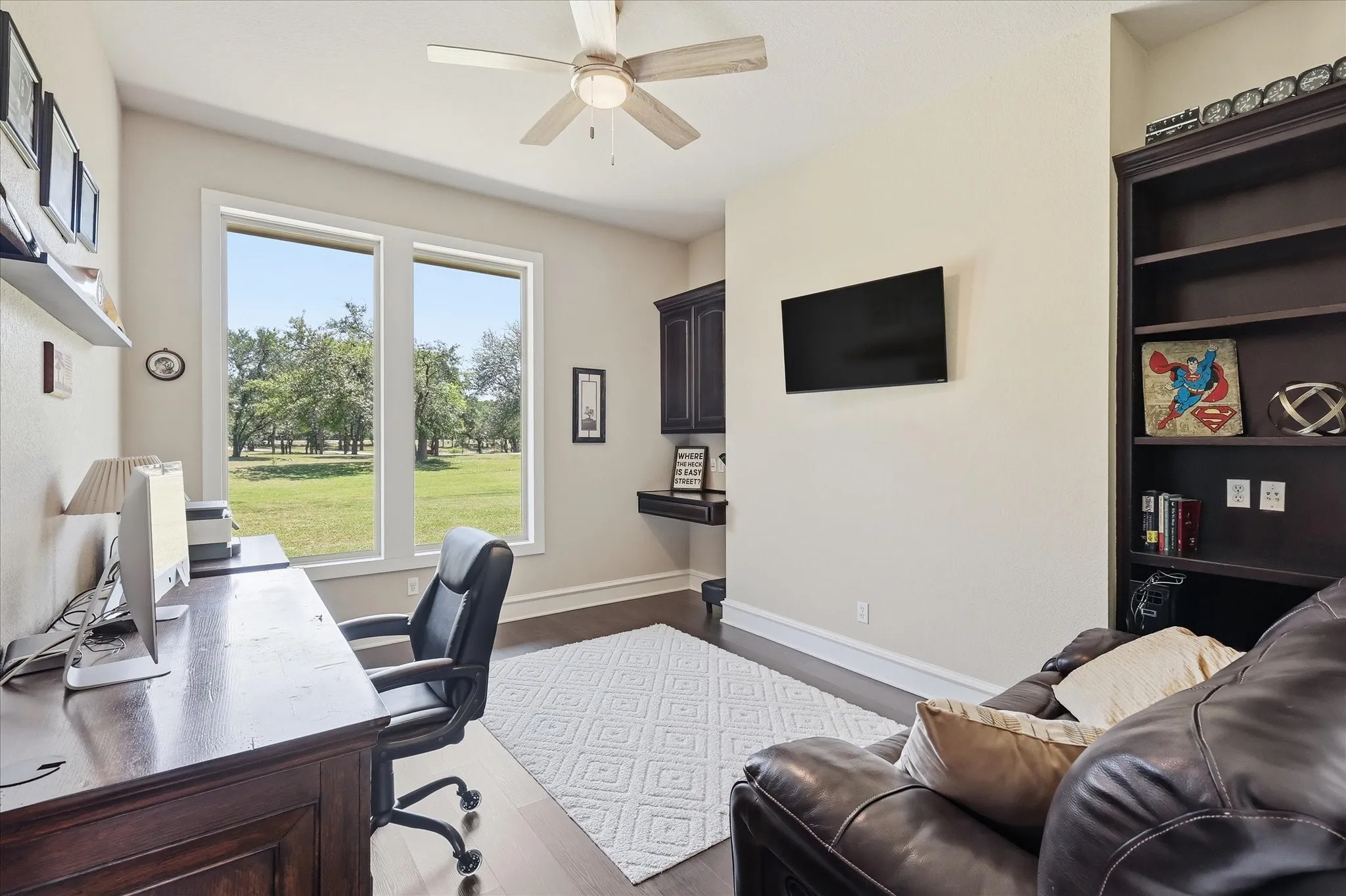Large Office with built in Book Shelves and Picture Windows.